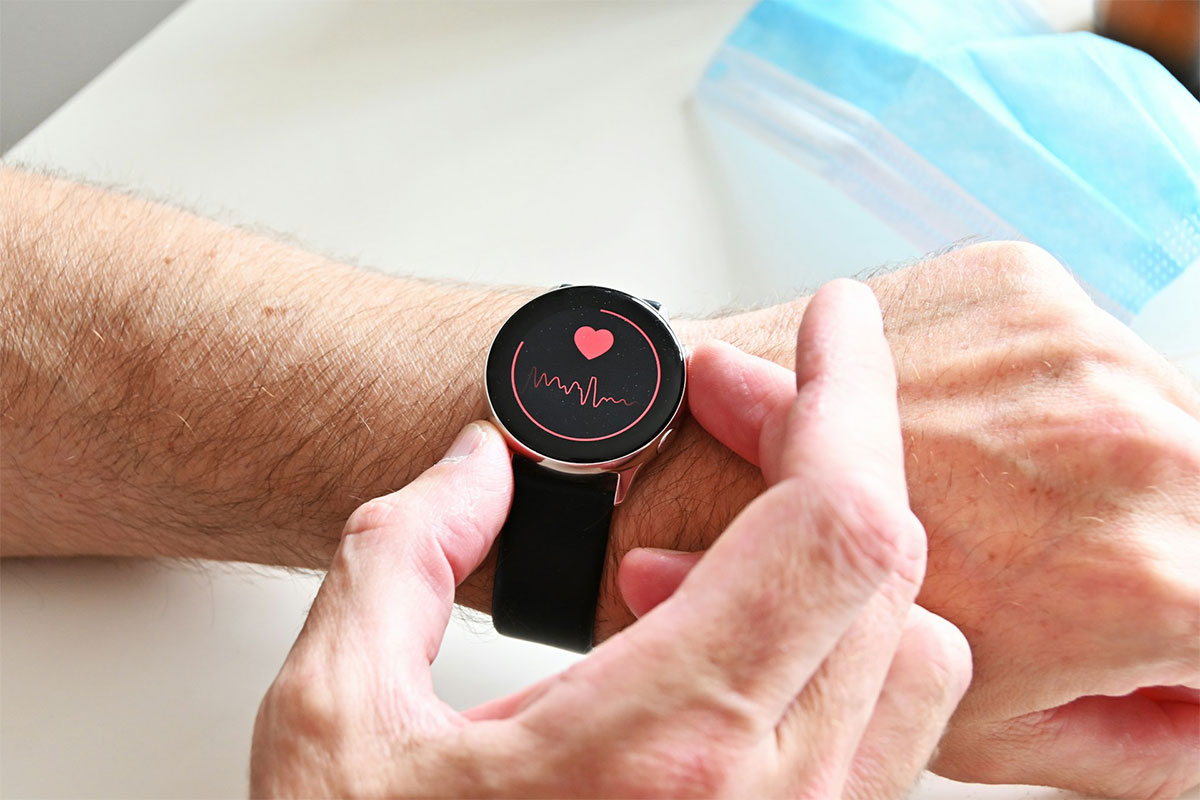 Person monitoring heart health with a smartwatch