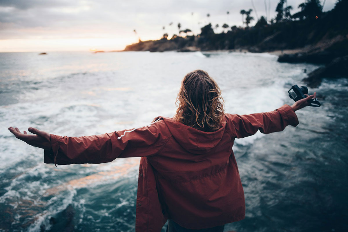 woman standing next to water