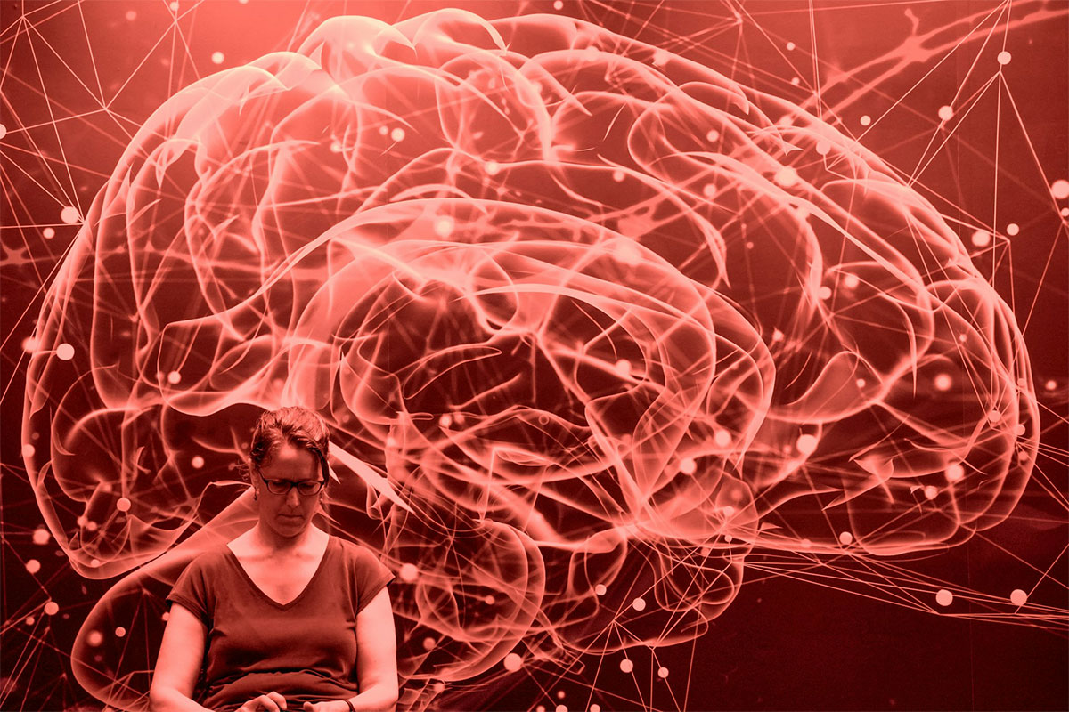 Woman studying with graphic of brian neurons in the background