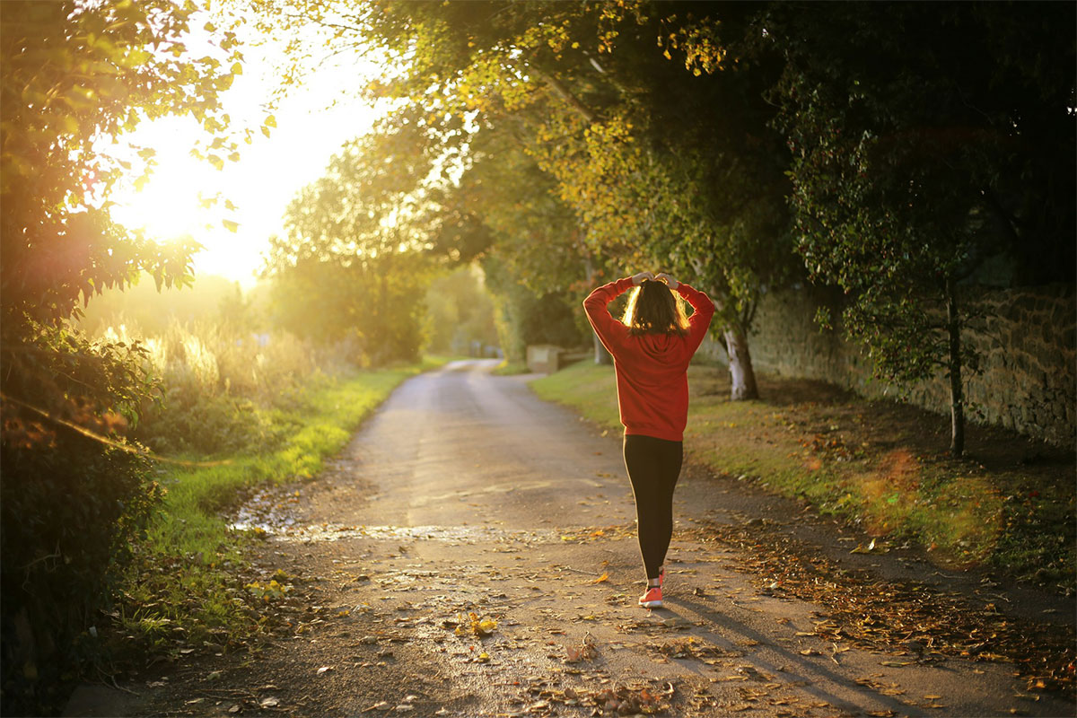 woman walking on a sunny path